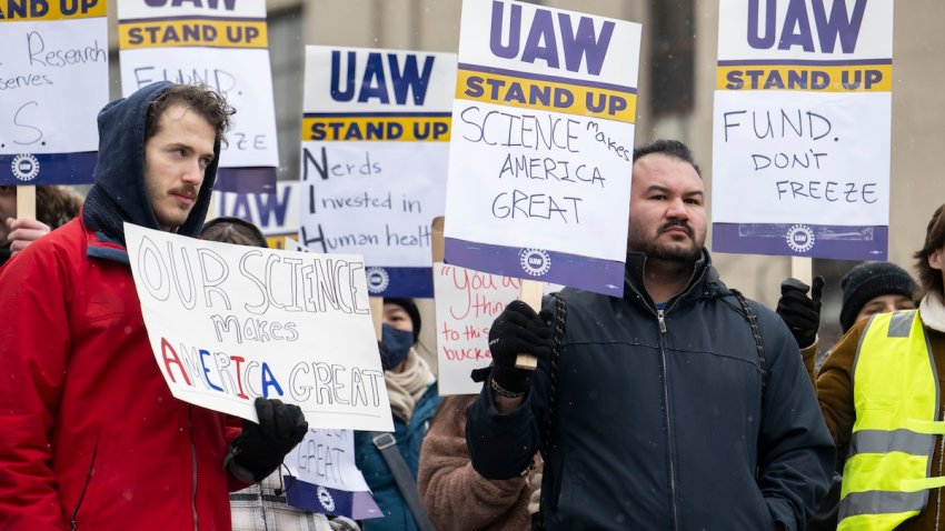 Jordan Lora, right, who worked as a post-bac in Dr. Lawrence Tabak’s lab, speaks during a protest against the Trump administration’s mass termination of over 1,000 federal employees at the National Institutes of Health outside of the U.S. Department of Health & Human Services in Washington, DC on February 19, 2025. A top-ranking scientist at the National Institutes of Health who worked for years as acting director of the NIH during the COVID-19 pandemic, Dr. Tabak was forced into retirement last week.