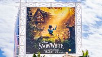 a billboard promoting the new Disney film "Snow White"
