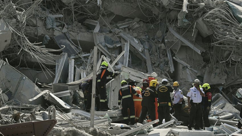 Rescue teams are seen at a collapsed building