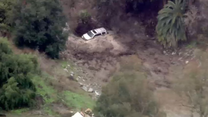 A SUV trapped in rushing creek water Thursday March 13, 2025 in San Juan Capistrano.