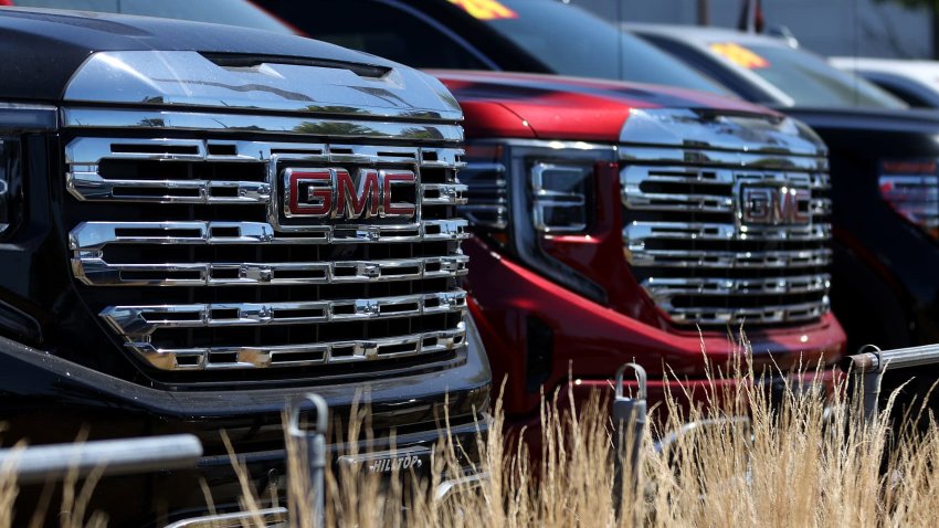 Brand new GMC trucks are displayed on the sales lot at Hanlees Hilltop GMC on July 02, 2024 in Richmond, California.
