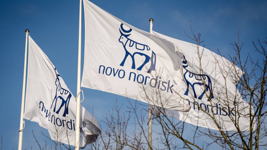 Flags with the logos of Danish drugmaker Novo Nordisk, maker of the blockbuster diabetes and weight-loss treatments Ozempic and Wegovy are pictures while the company presents the annual report at  Novo Nordisk in Bagsvaerd, Denmark, on February 5, 2025. 