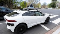 A Waymo self-driving car, seen with a driver, stops at a red light outside the U.S. Capitol in Washington, D.C., on Friday, March 31, 2025.