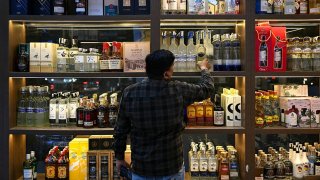 Liquor bottles are displayed at a store on the outskirts of New Delhi on April 3, 2025.