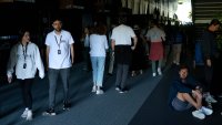 Fans walk through the dark gangways