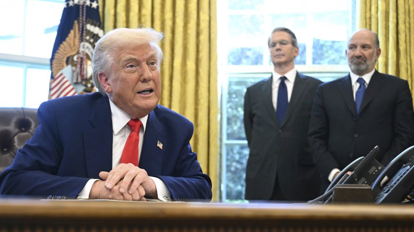 President Donald Trump speaks after signing an executive order in the Oval Office of the White House Wednesday, April 9, 2025, in Washington, as Treasury Secretary Scott Bessent and Commerce Secretary Howard Lutnick listen.