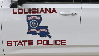 A Louisiana State Police vehicle parked on the street ahead