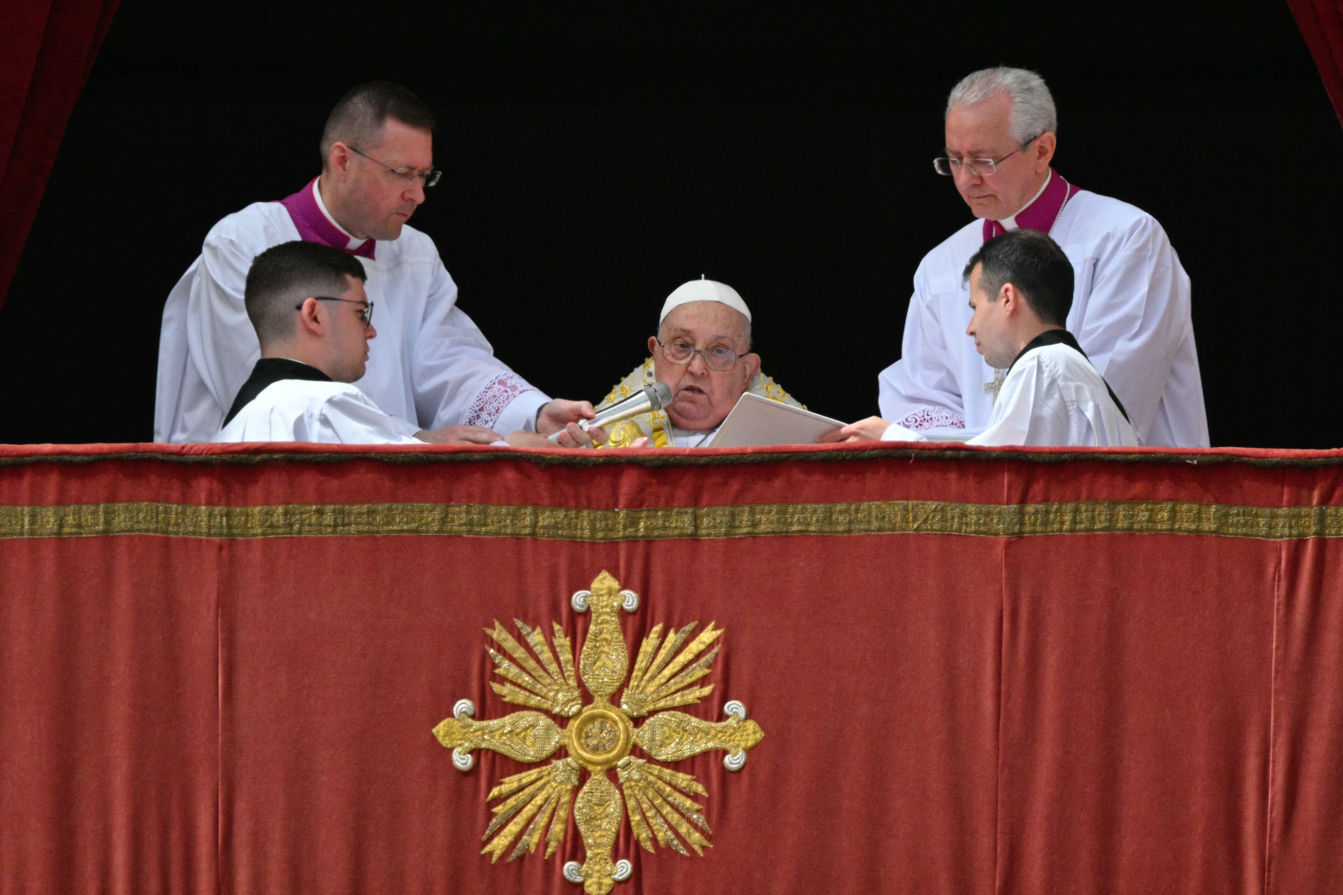 Pope Francis addresses the crowd from the main balcony of St. Peter’s basilica during the Urbi et Orbi message and blessing to the city and the world as part of Easter celebrations, at St Peter’s square in the Vatican on April 20, 2025.