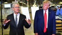 US President Donald Trump (r) and Apple CEO Tim Cook speak to the press during a tour of the Flextronics computer manufacturing facility where Apple’s Mac Pros are assembled in Austin, Texas, on November 20, 2019.