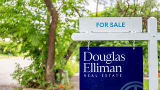 A for sale sign is displayed near a home on April 24, 2025 in Austin, Texas.
