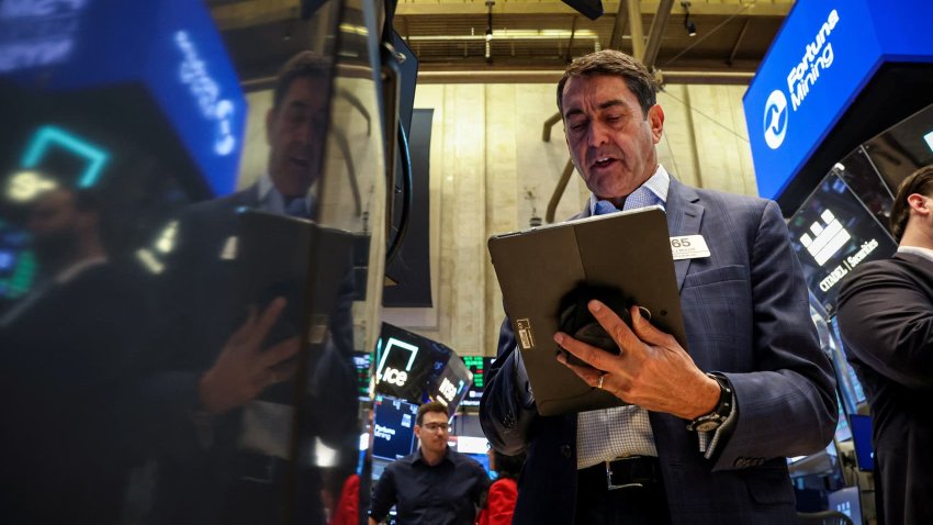 Traders work on the floor at the New York Stock Exchange on May 7, 2025.