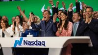 Yoni Assia, co-founder and CEO of eToro Group Ltd., center, and Ronen Assia, co-founder of eToro Group Ltd., center left, ring the opening bell during the company’s initial public offering at the Nasdaq MarketSite in New York, May 15, 2025.