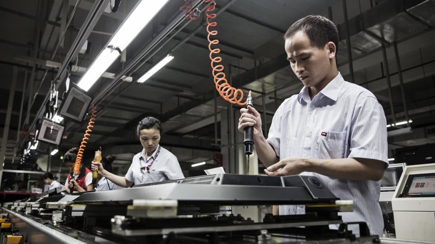 Workers assemble electronic devices in China in 2016.