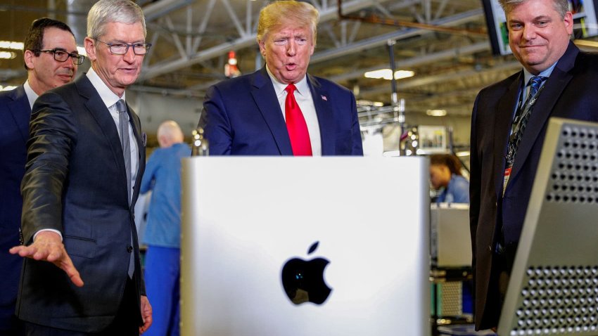 FILE PHOTO: Apple CEO Tim Cook escorts U.S. President Donald Trump as he tours Apple’s Mac Pro manufacturing plant with in Austin, Texas, U.S., November 20, 2019.