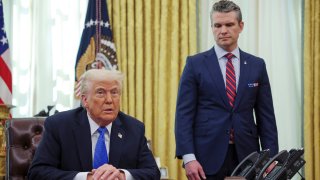 President Donald Trump, left, and Secretary of Defense Pete Hegseth listen during an event in the Oval Office of the White House in Washington, Friday, March 21, 2025.