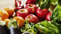 Closeup shot of fresh organic fruit and vegetables on a kitchen counter