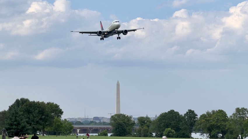 A Delta Airlines plane approaches to land at Ronald Reagan Washington National Airport in Arlington Virginia, on August 11, 2023, across from Washington, DC, and the Washington Monument.