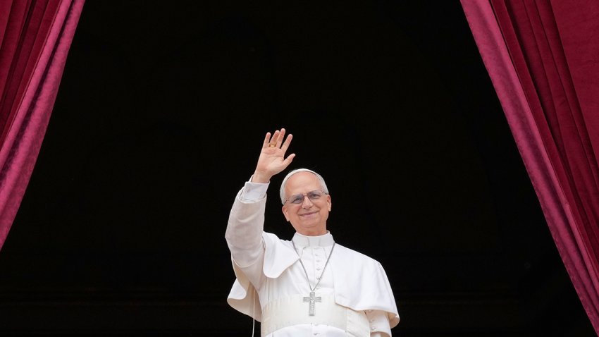 Pope Leo XIV appears on the central balcony of St. Peter's Basilica at the Vatican to bless the crowd below on May 11, 2025.