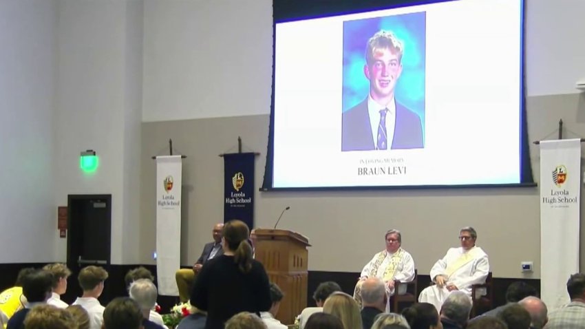 A photo of Braun Levi, 18, is displayed at a prayer vigil for the Loyola High School student.