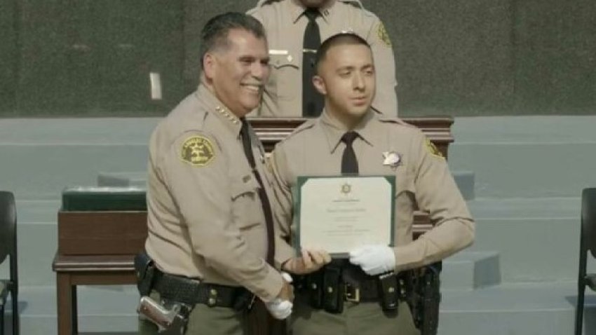 Deputy Daniel Valencia Chavira appears alongside Sheriff Robert Luna at a sheriff's department graduation ceremony.