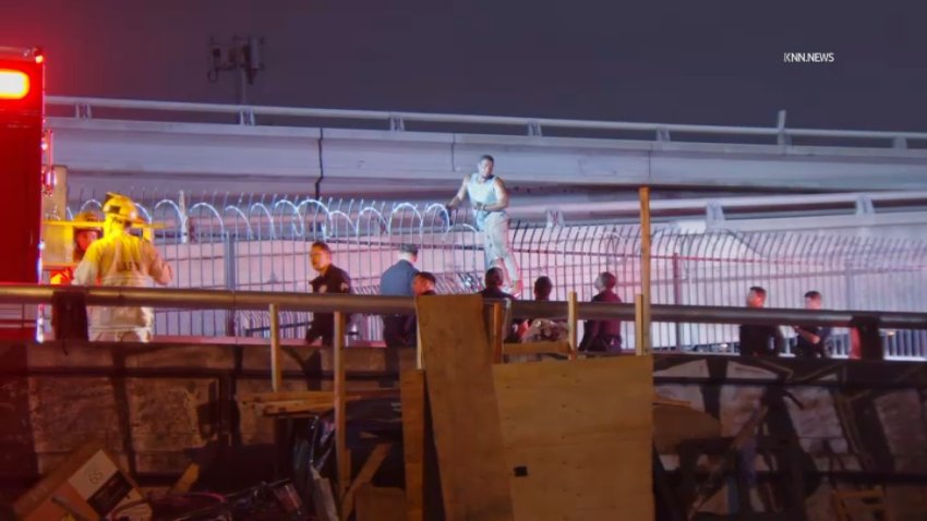 A man accused of vandalizing a downtown Los Angeles business on Friday, May 2, 2025 gets stuck on a fence while trying to get away.