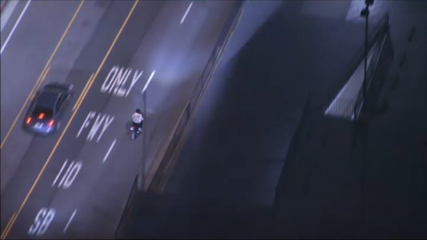 Police chase a motorcyclist on Monday, May 19, 2025.