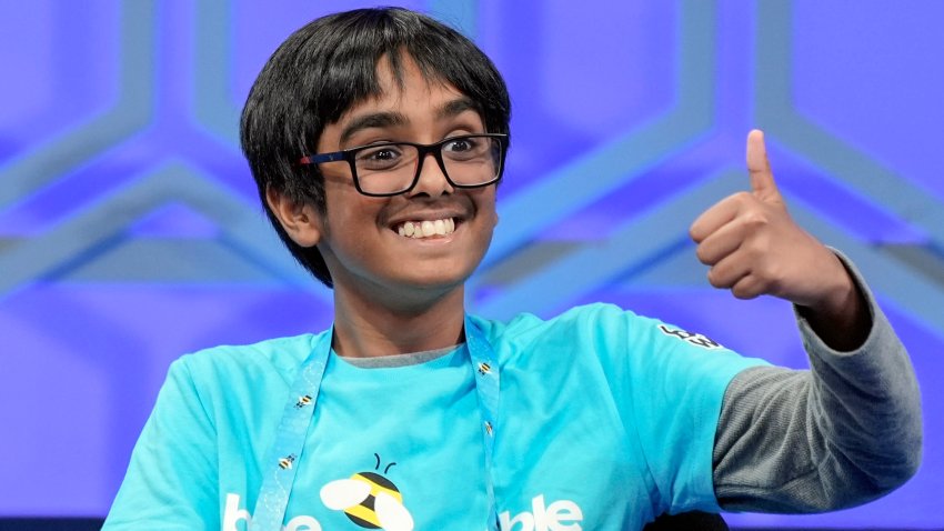 Faizan Zaki, 12, of Allen, Texas, gestures to his family after spelling his word correctly in the finals of the Scripps National Spelling Bee, in Oxon Hill, Md., May 30, 2024. (AP Photo/Mariam Zuhaib, File)