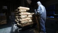 A worker handles sacks of brown rice at a Shinmei Co. plant in Kawaguchi, Saitama Prefecture, Japan, on Tuesday, Sept. 24, 2024. Bags of rice are expected to start filling the shelves of Japan’s supermarkets again soon as farmers harvest their new crop, though the increase in supply will do little to tame higher prices. Photographer: Kiyoshi Ota/Bloomberg via Getty Images