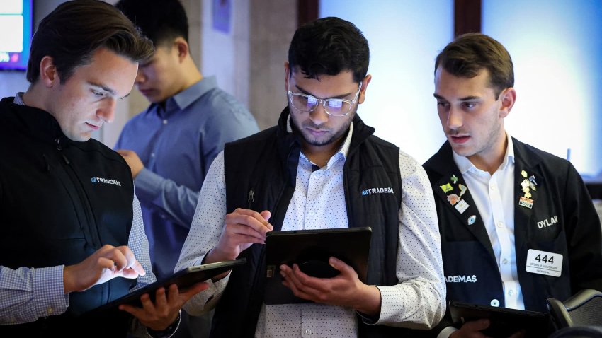 Traders work on the floor at the New York Stock Exchange on June 23, 2025.