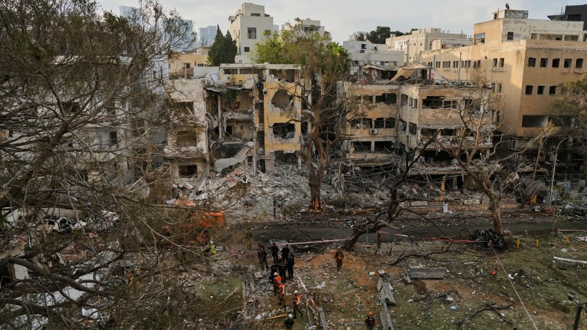 Rescue team work at the site where a missile launched from Iran struck Tel Aviv, Israel, Monday, June 16, 2025.