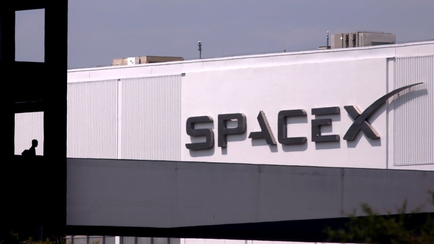 An employee prepares to cross the bridge from parking to SpaceX in Hawthorne on July 17, 2024. Elon Musk said Tuesday on X that he is moving the headquarters of both SpaceX and the social media platform formerly known as Twitter to Texas  citing several criticisms he has of California.