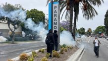 PARAMOUNT, CA - JUNE 7, 2025: People keep away from tear gas during protests against ICE and immigration raids, in Paramount, Ca., on Friday, June 7, 2025. (Myung J. Chun / Los Angeles Times via Getty Images)