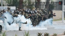 Paramount, CA - June 07: in Paramount - Police kick tear gas back to the crowd as people block off the street and set a fire during protests against ICE and immigration raids on Saturday, June 7, 2025 in Paramount, CA. (Myung J. Chun / Los Angeles Times via Getty Images)