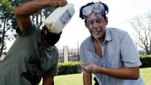 Los Angeles, CA - June 07: Anti-ICE protesters use milk to wash out tear gas from each other's eyes on E Alondra Blvd. on Saturday, June 7, 2025 in Los Angeles, CA. (Carlin Stiehl / Los Angeles Times via Getty Images)