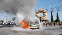 Los Angeles, CA - June 07: A car burns in the middle of the intersection of Atlantic Ave. and E Alondra Blvd. during ICE protests on Saturday, June 7, 2025 in Los Angeles, CA. (Carlin Stiehl / Los Angeles Times via Getty Images)