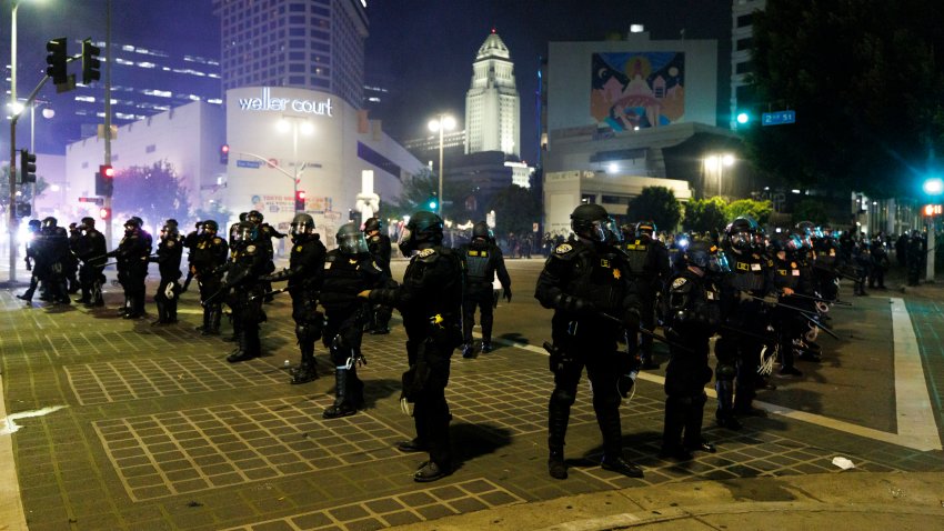LAPD creates a perimeter to move back anti-ICE protesters.