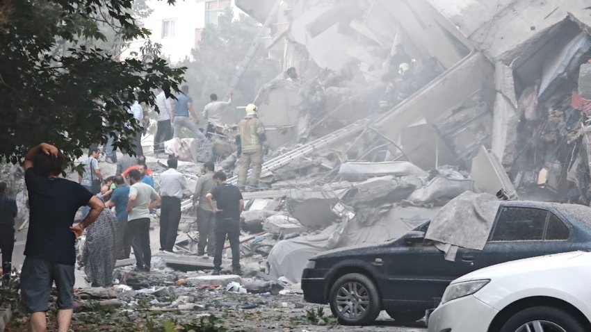 People look over damage to buildings in Nobonyad Square following Israeli airstrikes on June 13, 2025 in Tehran, Iran.