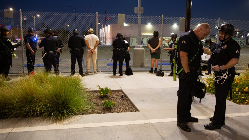 13 June 2025, US, Los Angeles: LAPD officers arrest demonstrators who did not leave the curfew zone after 8pm on June 13, 2025 in Downtown Los Angeles on June 13, 2025 after a demonstration against immigration raids by ICE. Photo: Zin Chiang/dpa (Photo by Zin Chiang/picture alliance via Getty Images)
