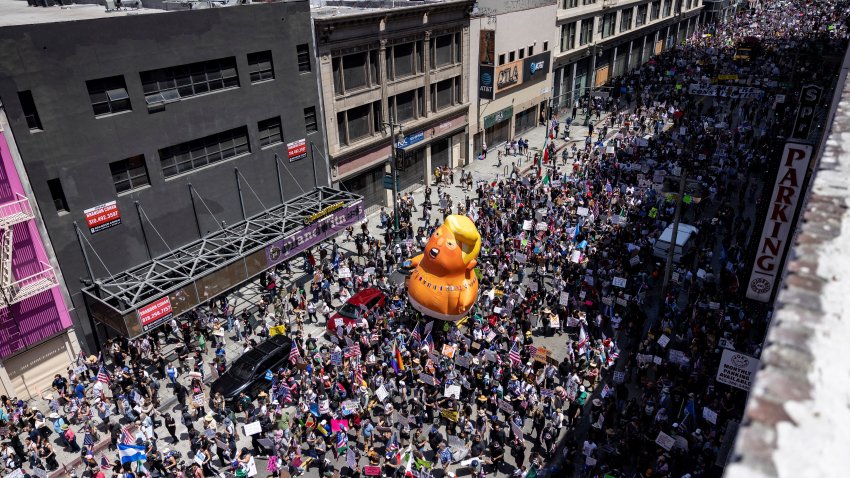 A 20-foot (6m)-tall balloon of US President Donald Trump in a diaper is seen among people taking part in a “No Kings” protest in Los Angeles, California, on June 14, 2025 as Trump presides over a military parade in Washington, DC. Trump will preside over a huge military parade in Washington on his 79th birthday, as nationwide protests rejecting his brand of politics underscore deep divisions over his second term. But the threat of thunderstorms in the US capital, and the barrage of missiles raining down in Tel Aviv and Tehran — a conflict in which the American military is assisting — could cast a long shadow over the president’s celebration. Nearly 7,000 troops plus dozens of tanks and helicopters will rumble through Washington in an event officially marking the 250th anniversary of the US army — at a cost of up to $45 million. (Photo by ETIENNE LAURENT / AFP) (Photo by ETIENNE LAURENT/AFP via Getty Images)