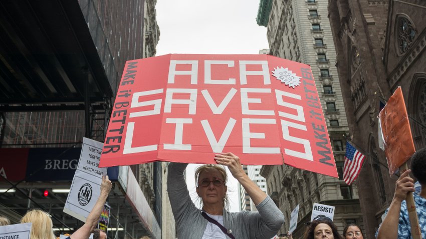 MIDTOWN, NEW YORK, NY, UNITED STATES – 2017/07/29: Participants hold signs while protesting the repeal and replacement of the Affordable Care Act.  At back-to-back rallies in midtown Manhattan, liberal activists rallied against President Trumps intentions to disallow transsexual officers to serve in the U.S. armed forces and then rallied to denounce efforts by the President and Republican politicians to repeal and replace the Affordable Care Act (i.e. Obamacare).