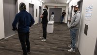 Plainclothes Immigration and Customs Enforcement officers wait in the hallway of a federal courthouse in New York City on Tuesday.