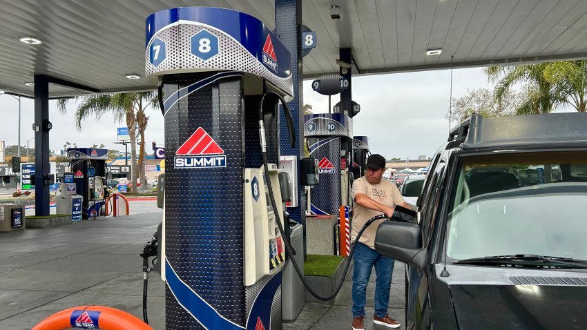 Samuel Almira fills up his car with gasoline, Sunday morning, in the Midway district before driving back home to Tijuana, June 29, 2025.
