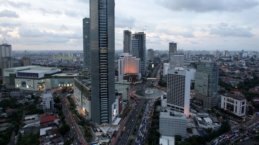 Traffic moves through the buildings in downtown Jakarta, Indonesia.