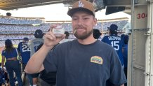 Lifelong Los Angeles Dodgers fan, Randy Johnson, poses with Shohei Ohtani's first home run ball in the right field pavilion at Dodger Stadium on October 17, 2025. Ohtani hit three homers in Game 4 of the NLCS against the Milwaukee Brewers and also got the win on the mound throwing six shutout innings with 10 strikeouts.