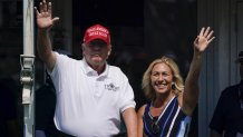 Former President Donald Trump, left, acknowledges the crowd with U.S. Rep. Marjorie Taylor Greene while they look over the 16th tee during the second round of the Bedminster Invitational LIV Golf tournament in Bedminster, NJ., Saturday, July 30, 2022. (AP Photo/Seth Wenig)