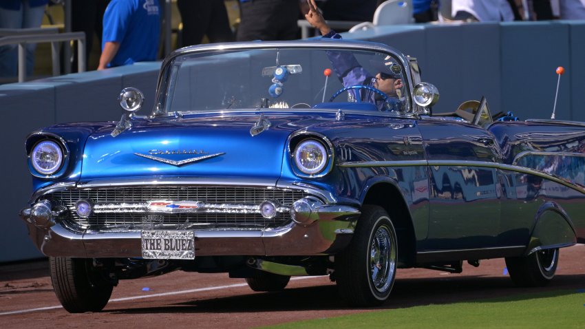 Ice Cube delivers the Los Angeles Dodgers Commissioner trophy driving his 1957 Chevrolet Bel Air.