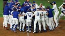 LOS ANGELES, CALIFORNIA - OCTOBER 27: Freddie Freeman #5 of the Los Angeles Dodgers is congratulated by teammates after hitting a walk-off home run during the 18th inning against the Toronto Blue Jays in game three of the 2025 World Series at Dodger Stadium on October 27, 2025 in Los Angeles, California. (Photo by Harry How/Getty Images)