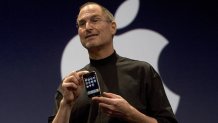 SAN FRANCISCO, CA - JANUARY 9: Apple CEO Steve Jobs holds up the new iPhone that was introduced at Macworld on January 9, 2007 in San Francisco, California. The new iPhone will combine a mobile phone, a widescreen iPod with touch controls and a internet communications device with the ability to use email, web browsing, maps and searching. The iPhone will start shipping in the US in June 2007.   (Photo by David Paul Morris/Getty Images)
