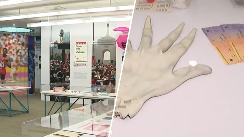Glass display cases and artifacts from an exhibit dedicated to the 1984 Olympics in Los Angeles.