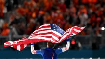 USA's Jordan Stolz waves his country's flag after winning gold